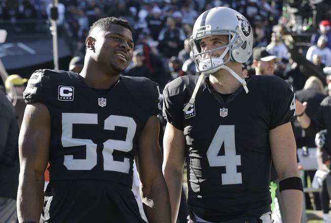 Raiders defensive end Khalil Mack (52) and quarterback Derek Carr (4) before a game against the Colts in Oakland, Calif., Saturday, Dec. 24, 2016.