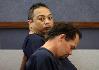 Rolando Cardenas, left, waits to make an initial court appearance Wednesday, March 29, 2017, at the Regional Justice Center. Cardenas has been charged with killing one passenger and wounding another on a double-decker bus last weekend on the Las Vegas Strip.