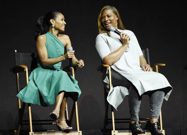 Jada Pinkett Smith, left, and Queen Latifah, cast members in the upcoming film "Girls Trip," share a laugh onstage during the Universal Pictures presentation at CinemaCon 2017 at Caesars Palace on Wednesday, March 29, 2017, in Las Vegas. (Photo by Chris Pizzello/Invision/AP)