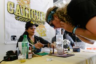 A VIP attendee inhales THC wax–also known as dabs–from a dab rig during the 4th annual Hempfest at Craig Ranch Regional Park in Las Vegas, Saturday, April 1, 2017.
