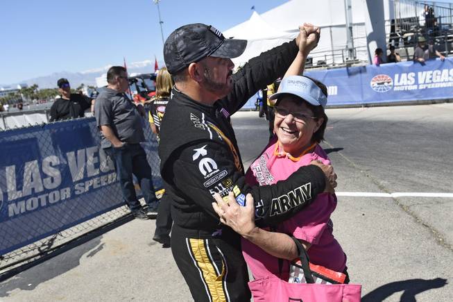 Top fuel driver Tony Schumacher dances with a fan during driver introductions at the NHRA DENSO Spark Plug Nationals at The Strip at the Las Vegas Motor Speedway Sunday, April 2, 2017.