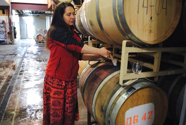 Guide Dina Ribaudo pulls 2014 Bordowie from a barrel for a tour group at Page Springs Cellars in Cornville, Ariz.