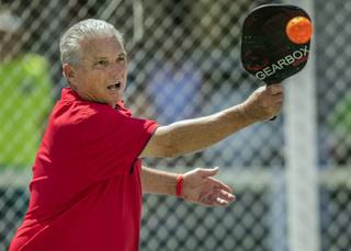 Curtis Irwin slices a return as he competes with his wife DeeDee in the 60 plus 4.0 bracket during the Sin City Showdown pickleball tournament at the Plaza Hotel on Saturday, April 8, 2017.
