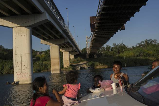 A family picnics on the banks of the Rio Grande in Miguel Aleman, Tamaulipas state, Mexico, located across the river from Roma, Texas, on March 22.