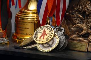 Kettlebell medals and trophies like a shelf at Kettlebell Sanctuary, 6520 S. Buffalo Dr., Wednesday, April 12, 2017.