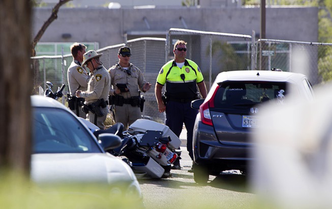 Henderson Police investigate an accident between Henderson Police motorcycle officer ...