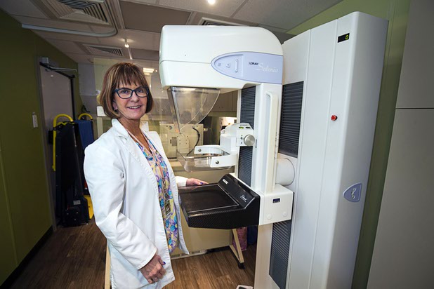 Patti Schmalhofer poses by a mammography system in the Nevada Health Centers Mammovan Wednesday, April 19, 2017.