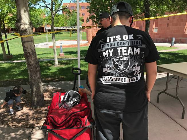 A fan wears a Raiders T-shirt outside a meeting of the Las Vegas Stadium Authority on Thursday, April 20, 2017. The Raiders will move from Oakland to Las Vegas after construction of a new stadium is completed.