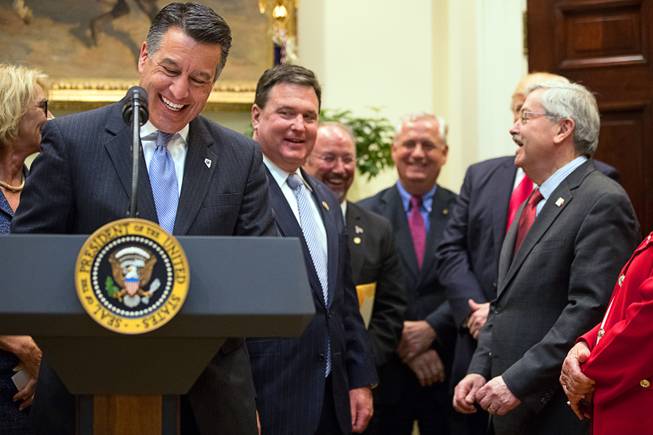 Gov. Brian Sandoval, left, laughs whiles speaking before President Donald Trump signs the Education Federalism Executive Order during a federalism event with governors in the Roosevelt Room at the White House in Washington, Wednesday, April 26, 2017. 
