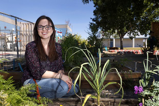 Ashleigh Schrodi, head of the garden team, poses in the Parson's Patch garden at Parson Elementary School Tuesday, May 2, 2017.