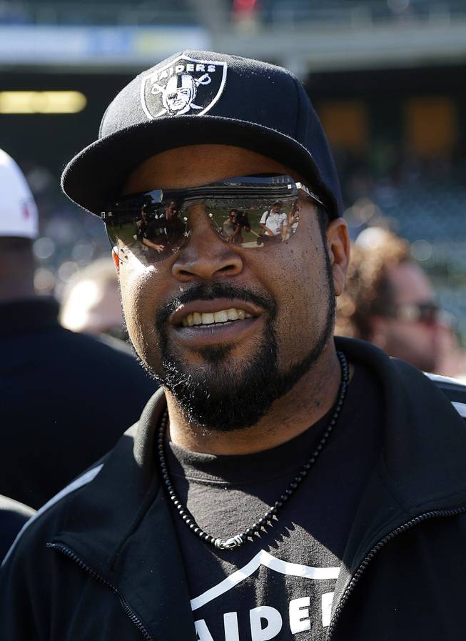 Rapper Ice Cube smiles before an NFL football game between the Oakland Raiders and the Arizona Cardinals in Oakland, Calif., Sunday, Oct. 19, 2014. 