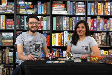 Albert Smedley and April Pena play King of Tokyo in their garage Sunday May 7, 2017.