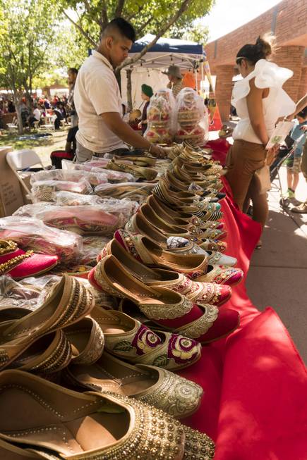A festival goer looks at shoes during the 14th annual ...