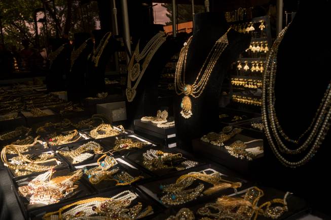 An array of jewelry is seen at a vendor booth ...