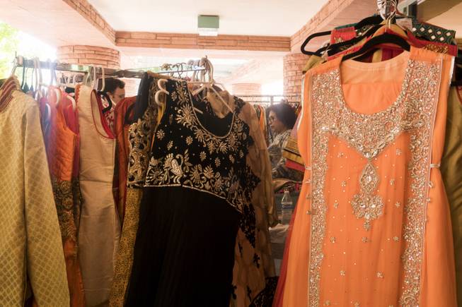 Dresses are seen on display at a vendor booth during ...