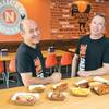 Michael Solomon, left, and Lance Graulich display a variety of the menu items they’ve created at WingTime. 