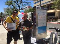 Kelly Fairchild (left) receives a surprise of balloons, a gift card and cupcakes from RTC Bicycle and Outreach Coordinator Ron Floth for being the bike share's 10,000th rider since it launched last fall in downtown Las Vegas.
