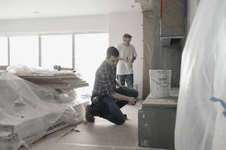 Jonathan Scott and a local contractor are filmed during a production day for the HGTV show, 