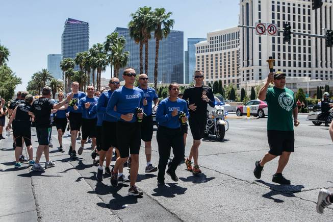 Clark County School District Police Department officers run north on Las Vegas Blvd. from the Linq to the Stratosphere Casino, Hotel & Tower for The Torch Run on May 12, 2017. The Torch Run is an annual tradition to raise money and awareness for Special Olympics Nevada and will feature the Flame of Hope being run from Boulder City all the way to Reno for the Summer Games on June 9.