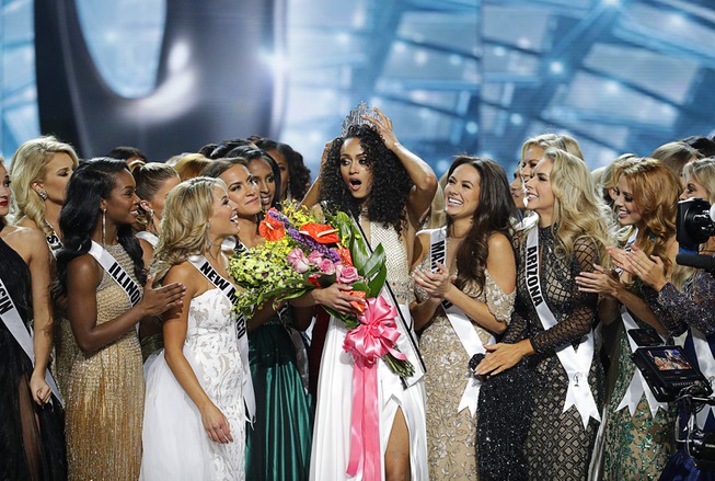 Miss District of Columbia USA Kara McCullough, center, reacts with ...