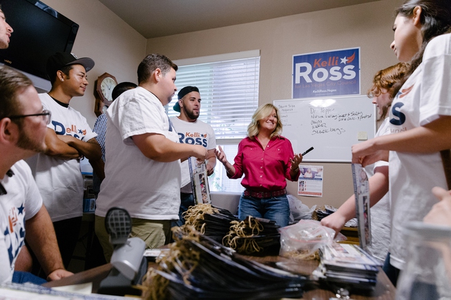 Kelli Ross, pink blouse, prepares her field team for canvasing ...