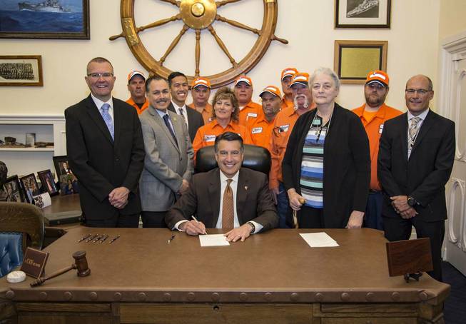 Gov. Brian Sandoval signs Assembly Bill 17, which amends the state's "Move Over Law," on May 15, 2017.