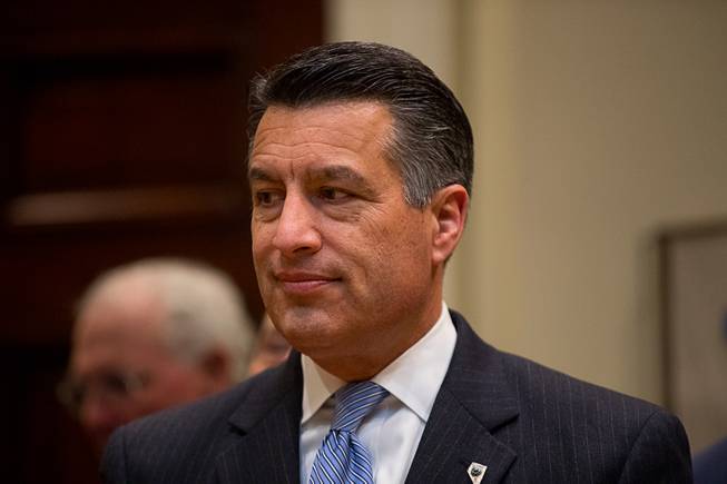 Gov. Brian Sandoval waits for President Donald Trump to arrive for a federalism event with governors in the Roosevelt Room at the White House in Washington, Wednesday, April 26, 2017. 