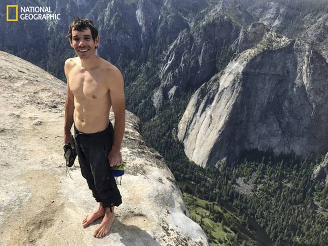 This Saturday, June 3, 2017, photo provided by National Geographic shows Alex Honnold atop El Capitan in Yosemite National Park, Calif., after he became the first person to climb alone to the top of the massive granite wall without ropes or safety gear. National Geographic recorded Honnold's historic ascent, saying the 31-year-old completed the "free solo" climb Saturday in nearly four hours. The event was documented for an upcoming National Geographic feature film and magazine story. 