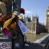 Flowers are seen at Westminster bridge to remember the terror attack on March 22, in London, Friday, April 7, 2017. 