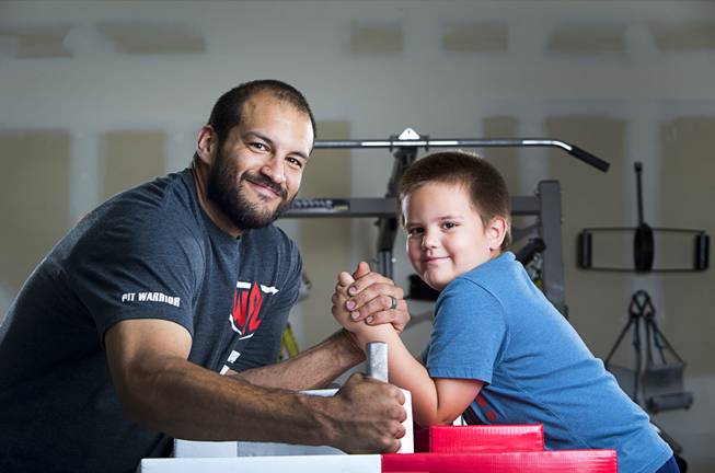 Arm wrestler Jeff Alexander poses with his son Tyler, 5, in his garage gym Sunday, June 11, 2017. Alexander is training for the World Armwrestling League Amateur Championships being held June 30 at the House of Blues in Mandalay Bay.