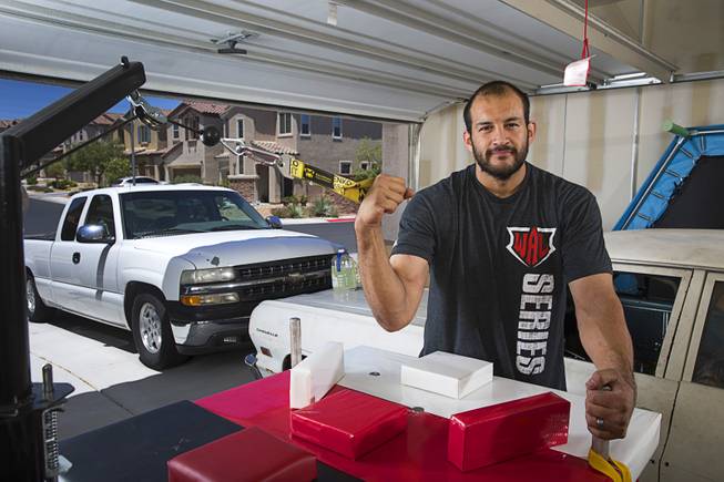 Arm wrestler Jeff Alexander poses in his garage gym Sunday, June 11, 2017. Alexander is training for the World Armwrestling League Amateur Championships being held June 30 at the House of Blues in Mandalay Bay.