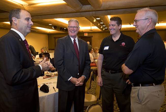 Outgoing Henderson Mayor Andy Hafen, second left, chats with Scott ...