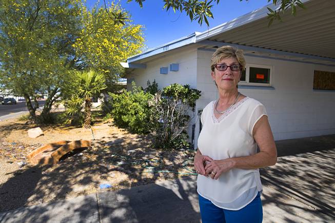 Clark County Commissioner Chris Giunchigliani poses in front of a home near Nellis Boulevard and Harmon Avenue Thursday, June 15, 2017. The home is vacant and was previously occupied by squatters.