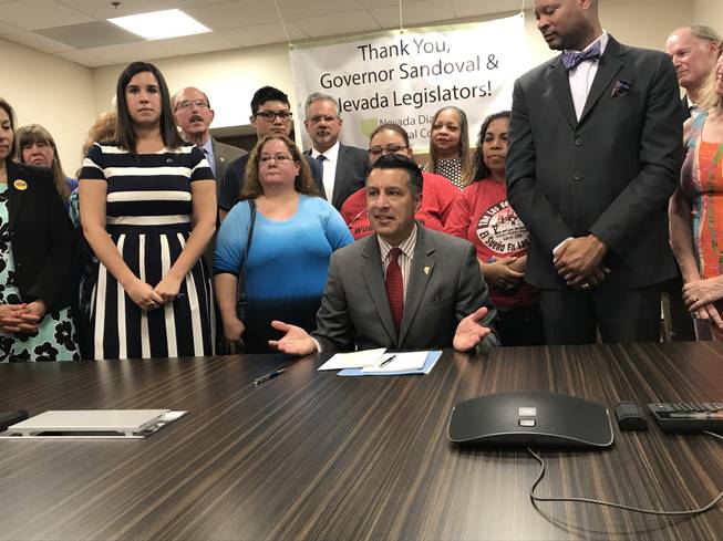 Gov. Brian Sandoval speaks before signing Senate Bill 539, which requires pharmaceutical companies to disclose the list prices they set and profits they make on insulin, on June 15, 2017, at the opening of the Culinary Health Center in Las Vegas.