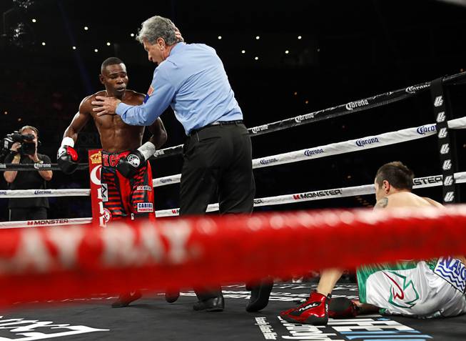 WBA super bantamweight champion Guillermo Rigondeaux of Cuba is held back by referee Vic Drakulich after knocking out Moises Flores of Mexico during their title fight at the Mandalay Bay Events Center Saturday, June 17, 2017 in Las Vegas.