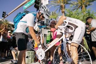 Pat Treichel, co-founder of Ghost Bikes Las Vegas, installs a memorial bike for Dr. Kayvan Khiabani outside of Red Rock Casino in Las Vegas, on Saturday, June 17, 2017. Dr. Khiabani died in a cycling accident on April 18.