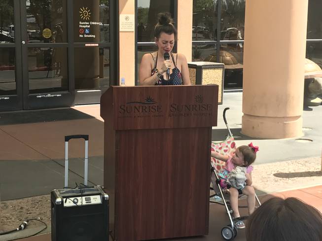 Marissa Endy-Vanchieri gets emotional while describing the day she found her daughter, Lily, right, submerged in their backyard pool. She spoke during an event at Sunrise Children's Hospital on  June 21, 2017, highlighting the importance of pool safety.
