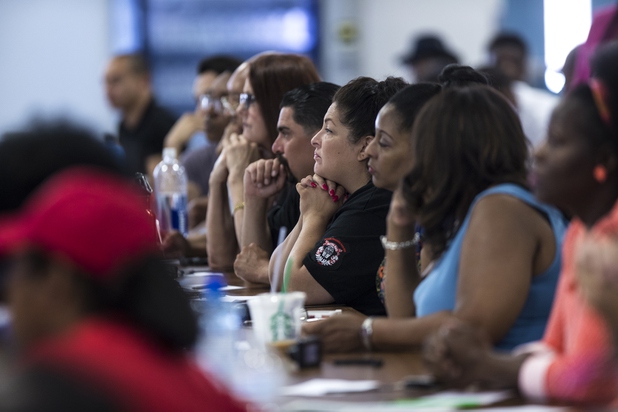 The crowd listens intently to speakers as the local chapter of the NAACP sponsors an info session and discussion on Nevada's legal process when someone is killed held at West Prep Academy on Friday, June 23, 2017.