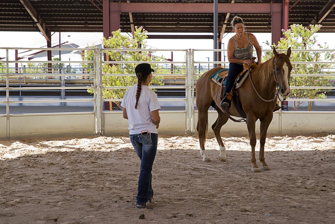 Horse trainer Katelynn Hentzell, left, talks with Gina Bell as ...