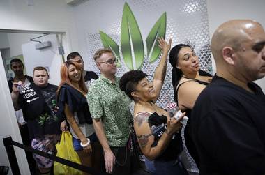 People wait in line at the Essence cannabis dispensary in Las Vegas, Saturday, July 1, 2017, as recreational sales of marijuana begin. 