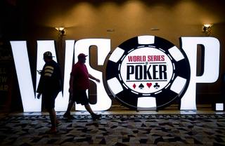 People pass by a WSOP sign in a hallway during day 2c of the World Series of Poker Main Event at the Rio Wednesday, July 12, 2017.