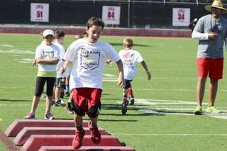 Kids running through conditioning drills during the Las Vegas Bowl youth football camp, Thursday, July 13, 2017. UNLV football hosted the Las Vegas Bowl youth football camp, Thursday, July 13, 2017.