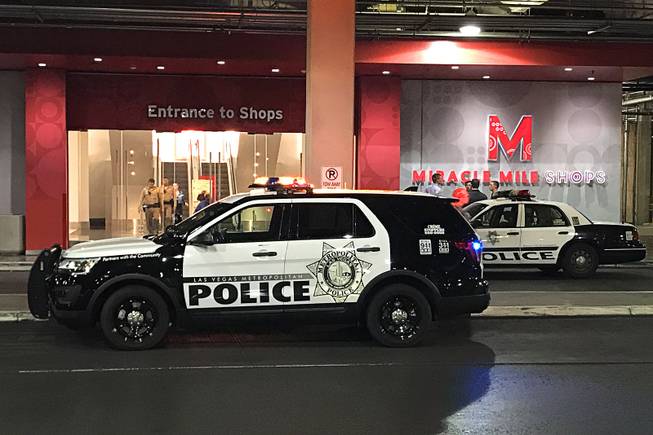 Metro Police cars are shown outside the Miracle Mile Shops, where a shooting took place Thursday, July 13, 2017.