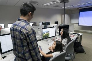 Instructor Carter Chiu, left, talks with middle school student Tiffany Zhan, center, and high schooler Jessica Li, right, about their UNO coding project during UNITE, a teacher-student STEM/Big Data 6-week camp, at UNLV, Tuesday, July 11, 2017. Clark County School District teamed up with UNLV to provide a crash course in Big Data programming for middle school, high school students and teachers to help the advancement of STEM education.