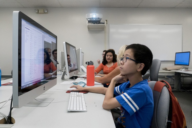Middle school student Joshua Yee, 12, works on his coding ...
