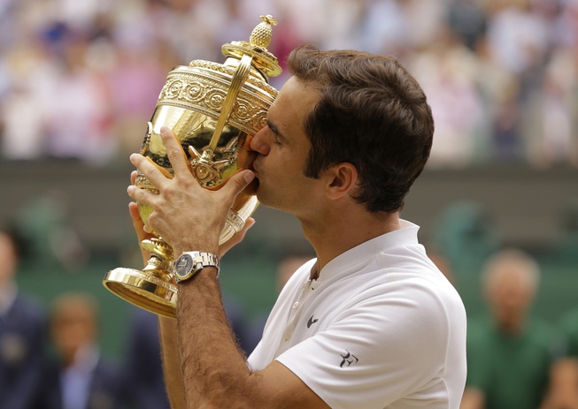 Switzerland's Roger Federer kisses the trophy after defeating Croatia's Marin ...