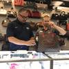 Michael Mack, left, and James McCracken of Max Pawn test the authenticity of a Louis Vuitton bag with the Entrupy microcamera device.