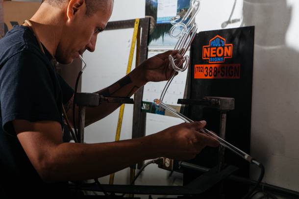 Paul Macias works on a sign at his shop Pauls Neon Signs in Las Vegas, Nev. on July 13, 2017.  The shop started in California in 1985 by his parents Ina & Juan Macias.
