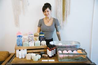 Audrey Hale of Roux and Bones Soaps stands next to a table of her handmade soap and bath products during the Maker's Market event at Sister House Collective in downtown Las Vegas, Saturday, July 15, 2017.