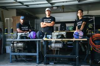 The founders of Revive Brand Co. from left Medin Gebrezgier, Jonathan Santos and his brother Cesar Santos pose for a photograph in their garage workshop in Las Vegas on Sunday, July 17, 2017.
